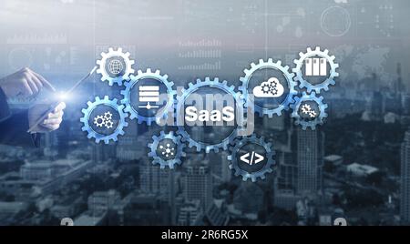SaaS Software as a Service concept with hand pressing text Stock Photo