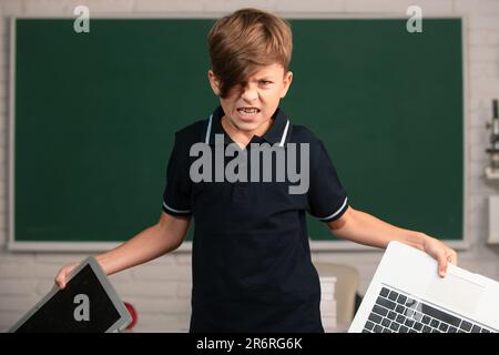 Angry boy in opposition distance education. School kid broken online ...