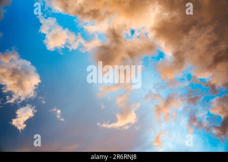 Beautiful dramatic orange clouds on blue sky in the evening Stock Photo