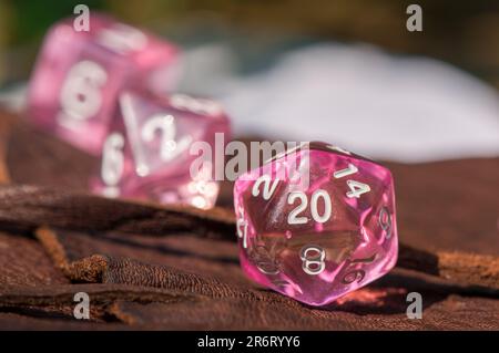 Macro image of a transparent pink 20-sided role-playing gaming die Stock Photo