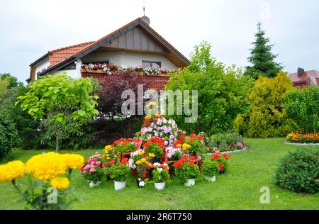 Flower pyramid in the garden, flower pot with flowers, lawn Stock Photo