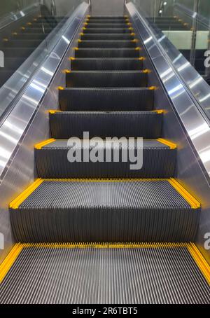 Mechanical escalator in building airport subway train station. Stock Photo