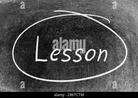 White chalk hand writing in word lesson and circle shape on blackboard background Stock Photo