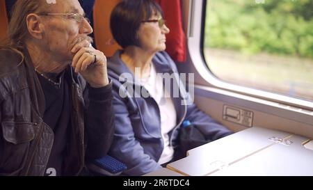 Warsaw, Poland. 11th June, 2023. Elderly couple is riding in a train carriage and looking out the window (Credit Image: © Andrey Nekrasov/ZUMA Press Wire) EDITORIAL USAGE ONLY! Not for Commercial USAGE! Stock Photo