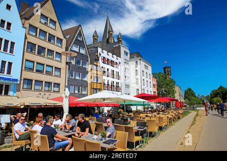 Cologne (Köln, Buttermarkt), Germany - June 6. 2023: Beautiful market square, riverside boardwalk, outside restaurant cafe terraces, old houses Stock Photo