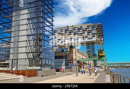 Cologne (Köln, Rheinauhafen), Germany - June 6. 2023: Beautiful rhine river bank waterfront cycle and walking promenade, modern Kranhaus architecture Stock Photo