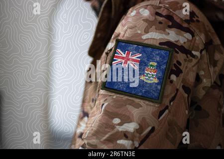 Cayman Islands Soldier, Soldier with flag Cayman Islands, Cayman Islands flag on a military uniform, Cayman Islands army, Camouflage clothing Stock Photo