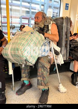 London, UK. 11th June, 2023. A home less beggar travelling in London Tube to keep his body and sole together. Credit: Seshadri SUKUMAR/Alamy Live News Stock Photo