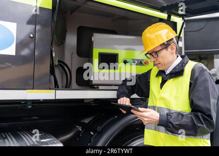 Worker with digital tablet operating construction machine equipment Stock Photo