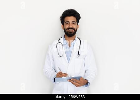 smiling young indian doctor posing on white background Stock Photo