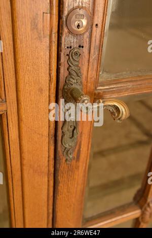 An ornate antique brass door handle at the historic Napoli Mergellina railway station, Naples, Italy Stock Photo