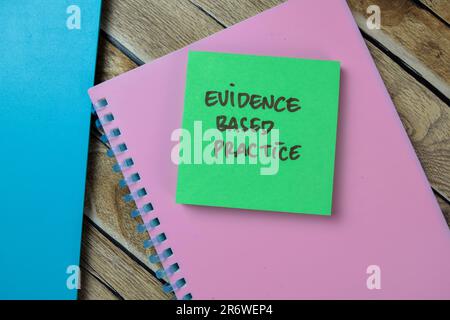 Concept of Evidence Based Practice write on sticky notes isolated on Wooden Table. Stock Photo