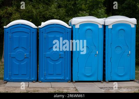 photo of blue public toilets standing outside Stock Photo