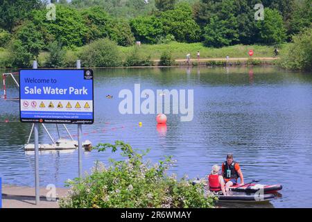 Sale Water Park, Trafford, Greater Manchester, man woman paddle boards, lake Stock Photo