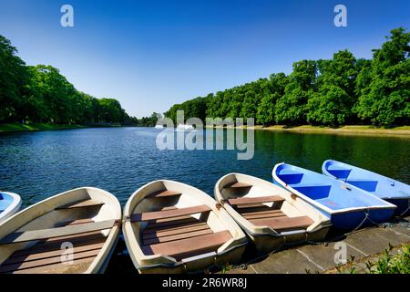 rowboats lying on the shore of bluecherpark in cologne on a sunny day Stock Photo