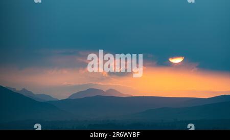 Killearn, Stirling, Scotland, UK. 11th June, 2023. UK weather: A vivid sunset over The Cobbler (Ben Arthur) and the Arrochar Alps, as seen from Killearn, Stirling, Scotland Credit: Kay Roxby/17�Թ����� Live News Stock Photo