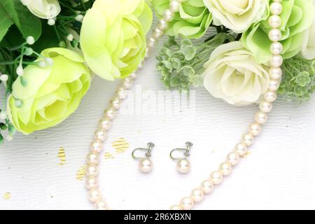 Elegant white pearl necklace and earrings on white background Stock Photo