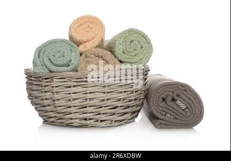 Wicker basket with rolled towels on white background Stock Photo