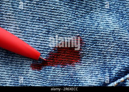 Stain of red ink on jeans, closeup Stock Photo - Alamy