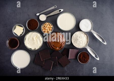 Hazelnut spread, dark chocolate, cream, and other cake ingredients Stock Photo