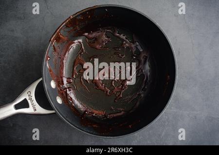 Empty used pot on a dark background viewed from directly above Stock Photo