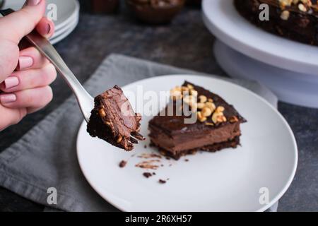 Dark chocolate and hazelnut mousse pie on a white plate with a fork Stock Photo