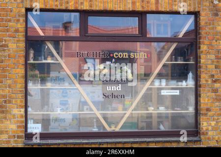 PRODUCTION - 25 May 2023, Saxony-Anhalt, Mühlbeck: 'Bücher com sum' and 'Hören und Sehen' are written in a shop window of a currently closed bookstore. Literature fans, book addicts and bookworms are drawn to Germany's first book village - but the antiquarian booksellers have no successors in sight 26 years after its founding. Photo: Klaus-Dietmar Gabbert/dpa Stock Photo