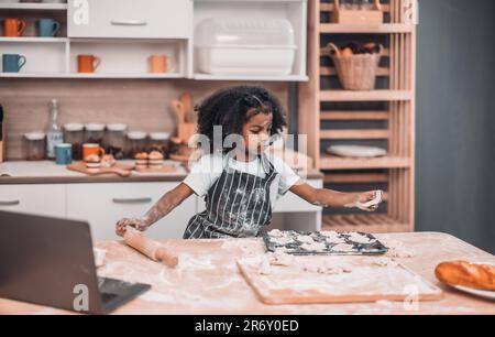 Family members cook homemade pizza dough in funny and playful ways. Mixing ingredients like salt, sugar, milk, yeast, oil then rubbing, massaging, pre Stock Photo