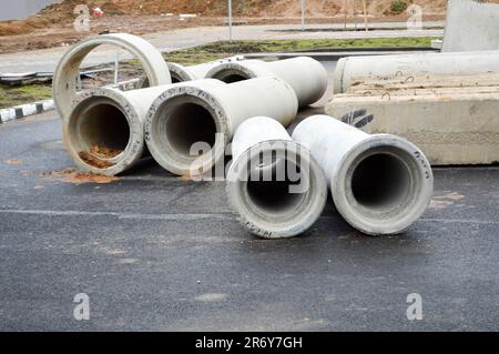 Large concrete stone cement sewer plumbing pipes of large diameter for the industrial construction of water supply or sewage at a construction site du Stock Photo