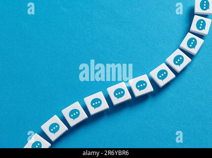 Communication chain. Online messaging or chat. Social networking. Information transfer. Chain of blocks with speech bubbles with three dots symbol. Stock Photo