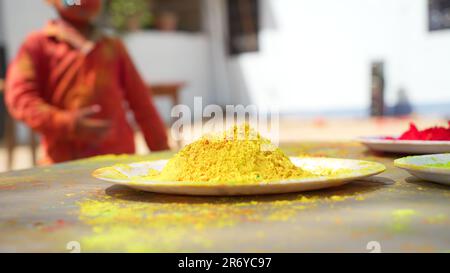 Indian Holi holiday. Holi celebration. Side view. Festive color on table setting. Holi concept. Decoration with paints Stock Photo
