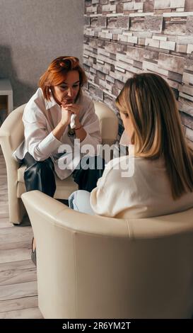 Female friend consoling desperate young woman. Stock Photo