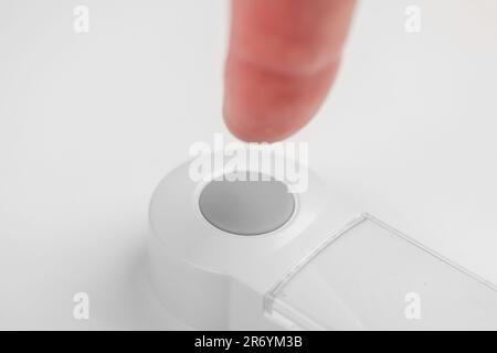 Patient hand pressing emergency nurse call button for help close up. Assistance concept Stock Photo