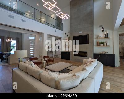 Living Room with Rug, Lighting Fixtures, and Kitchen View Stock Photo ...