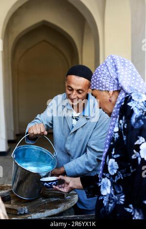 An Uzbek couple in the old city of Bukhara, Uzbekistan. Stock Photo