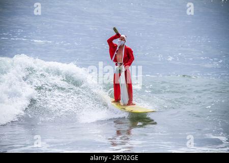 Surf in a carnival costumes, Bali, Indonesia. Stock Photo