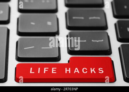 Red button with words Life Hacks on laptop, closeup Stock Photo
