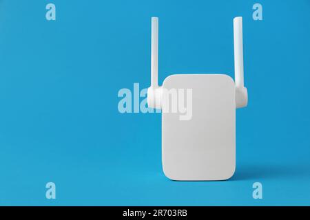 New modern Wi-Fi repeater on blue background, space for text Stock Photo