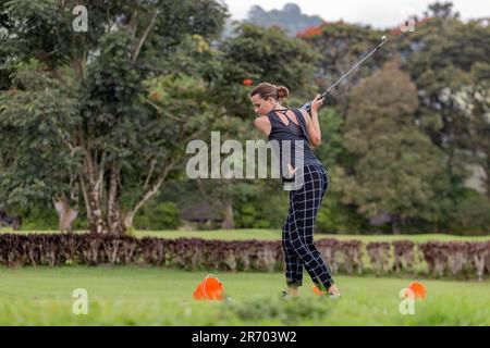 Woman playing golf, Bedugul, Bali, Indonesia Stock Photo