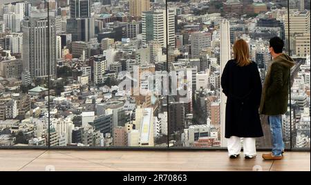 Tourist enjoying the views from the Shibuya Sky rooftop observation deck on top of the Scramble Square building in Shibuya, Tokyo, Japan. Stock Photo