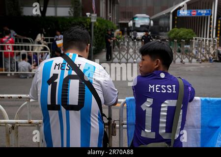 Chinese fans wearing Argentina soccer team jerseys as they gather near the  barricades outside a hotel to catch a glimpse of soccer superstar Lionel  Messi and other team players, ahead of the