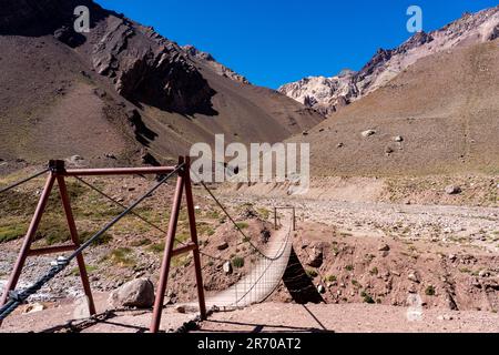 The suspension bridge over the Horcones River in Aconcagua Provincial Park, Mendoza Province, Argentina. Stock Photo