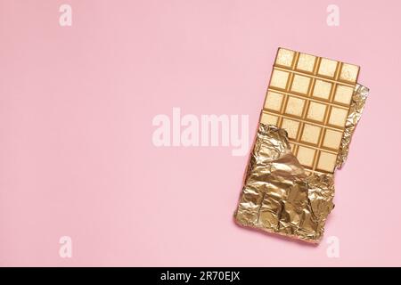 Bars of chocolate in gold foil, isolated on a white background Stock Photo  - Alamy