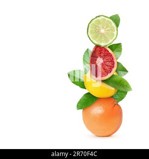 Stack of different fresh citrus fruits with green leaves on white background Stock Photo