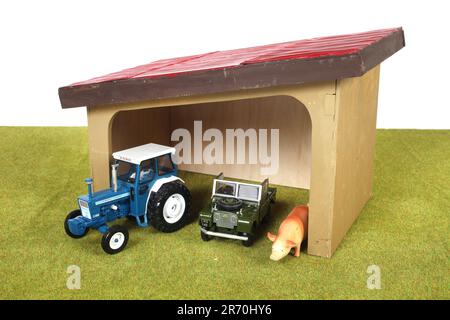 A wooden farmyard barn with tractor,Land Rover and pig Stock Photo