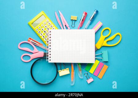 Blue school supplies with notebook on blue background. Back to school. Flat lay. Top view Stock Photo