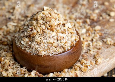 Crushed dried walnuts on the table, cut and crushed walnuts during cooking Stock Photo