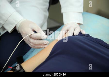 Electroneuromyography. A new direction in medicine is electroneuromyography. Neuromyography. Stock Photo