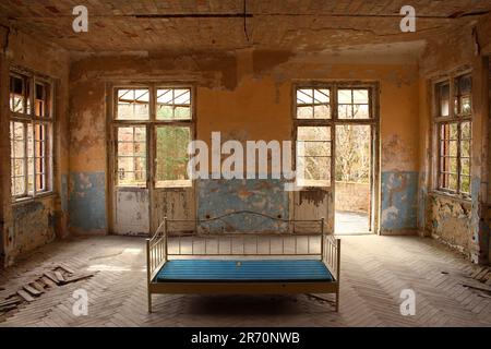 empty bed in a lost place hotel Stock Photo