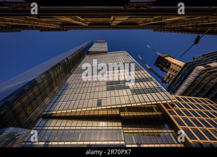 London, UK: Looking up at 8 Bishopsgate in the City of London with 22 Bishopsgate (left) and One Leadenhall under construction with cranes (right) Stock Photo